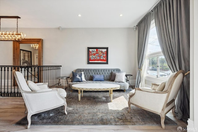 living room featuring an inviting chandelier and hardwood / wood-style floors