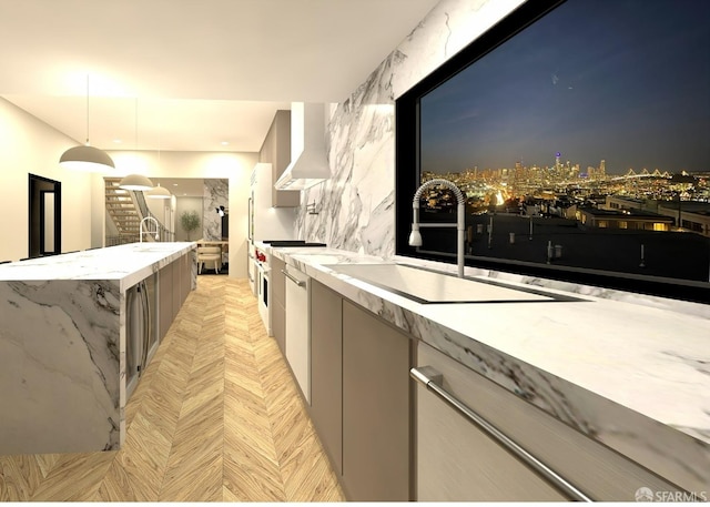 kitchen with stainless steel range oven, sink, hanging light fixtures, wall chimney exhaust hood, and light parquet floors