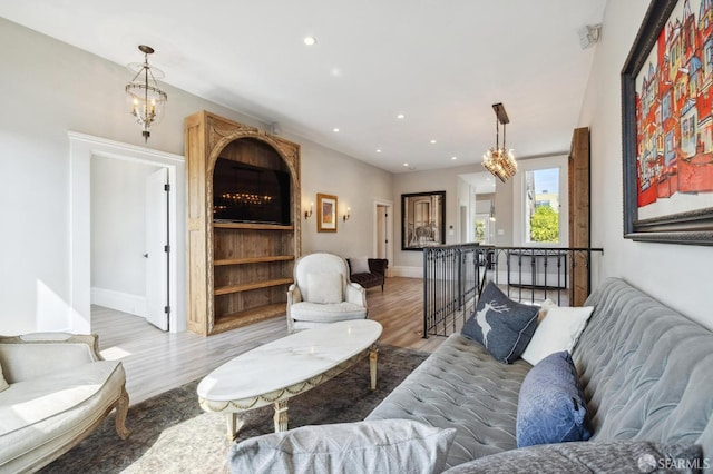 living room featuring a chandelier and hardwood / wood-style flooring