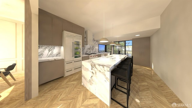 kitchen featuring white cabinetry, a breakfast bar, tasteful backsplash, a kitchen island, and light parquet floors