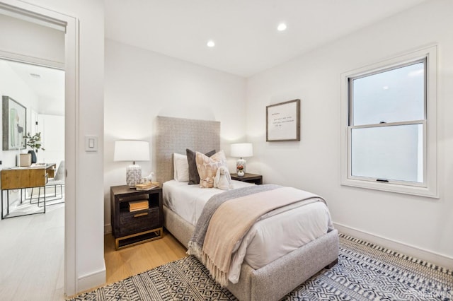 bedroom featuring light wood-style flooring, baseboards, and recessed lighting