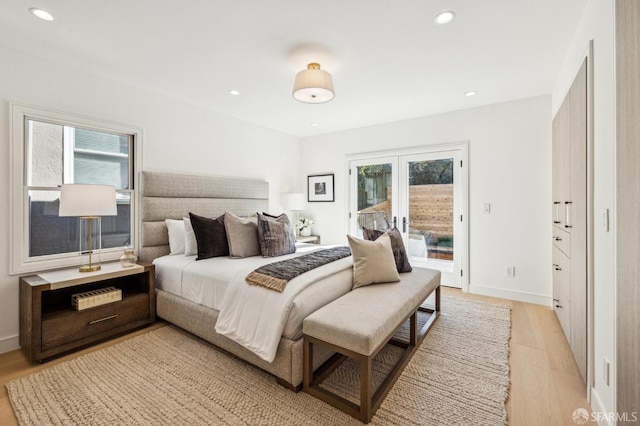 bedroom with access to outside, light wood-style flooring, and recessed lighting