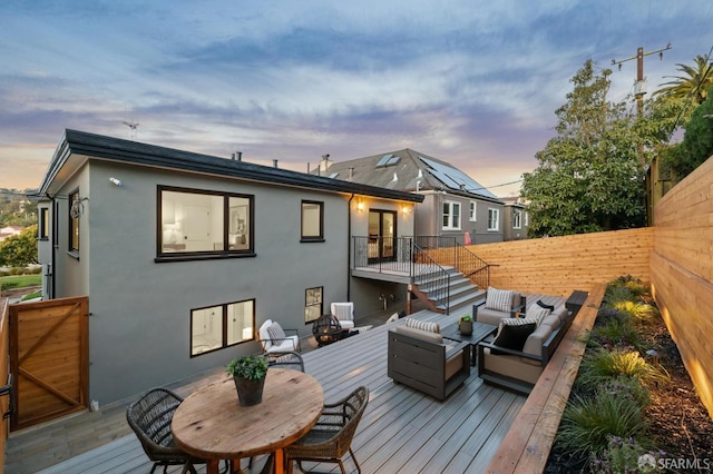 wooden deck featuring a fenced backyard and outdoor lounge area