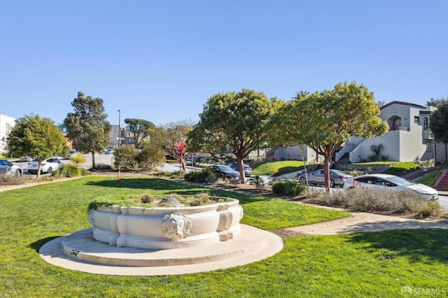 view of property's community featuring a yard