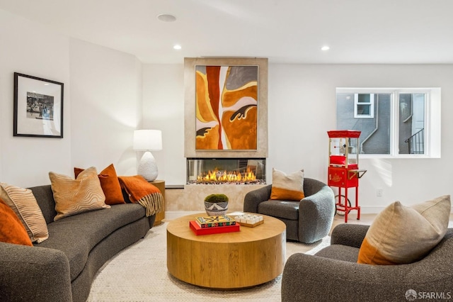 living room with recessed lighting and a multi sided fireplace