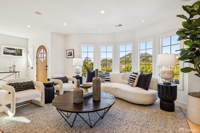 living area featuring visible vents and recessed lighting