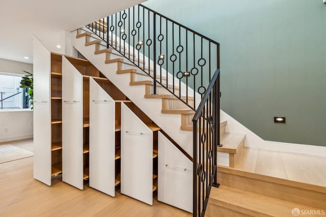 stairs featuring recessed lighting, wood finished floors, and baseboards