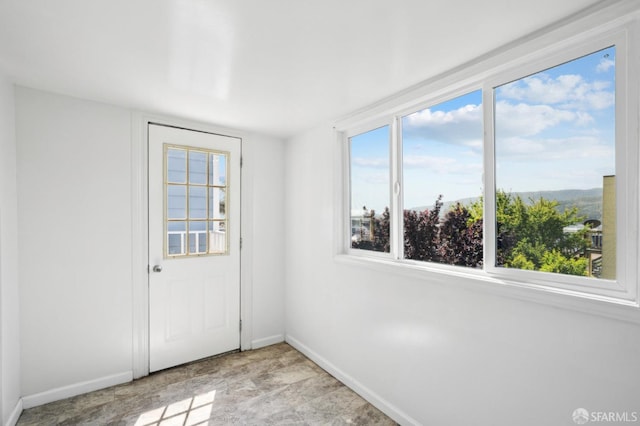 unfurnished room featuring baseboards