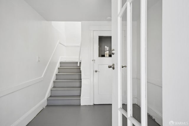 stairway with tile patterned floors