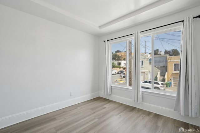 unfurnished room featuring baseboards and wood finished floors
