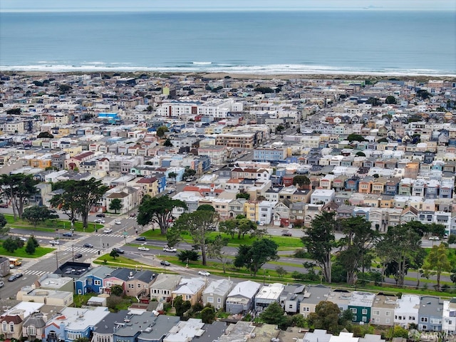 birds eye view of property with a water view and a beach view