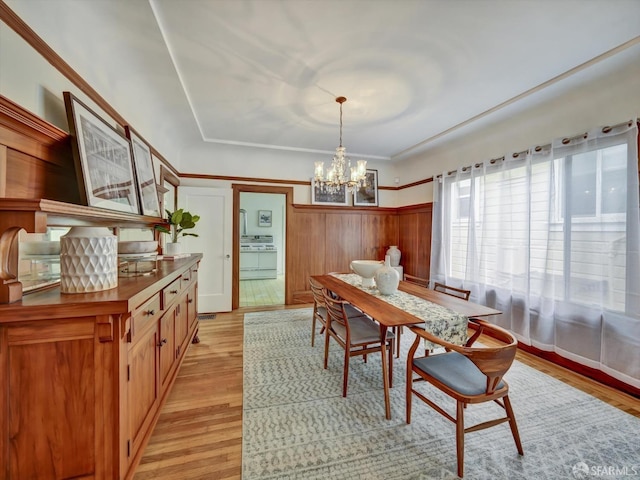 dining area with an inviting chandelier and light wood-type flooring