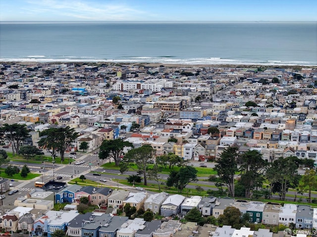 drone / aerial view with a beach view and a water view