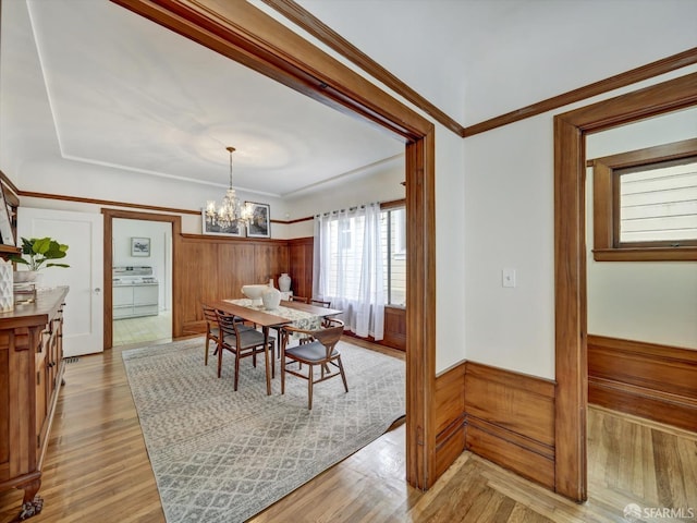 dining area with an inviting chandelier and light hardwood / wood-style flooring