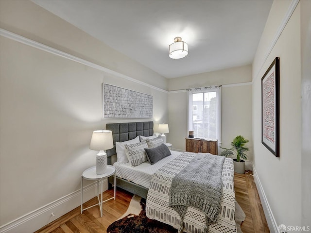 bedroom with hardwood / wood-style flooring