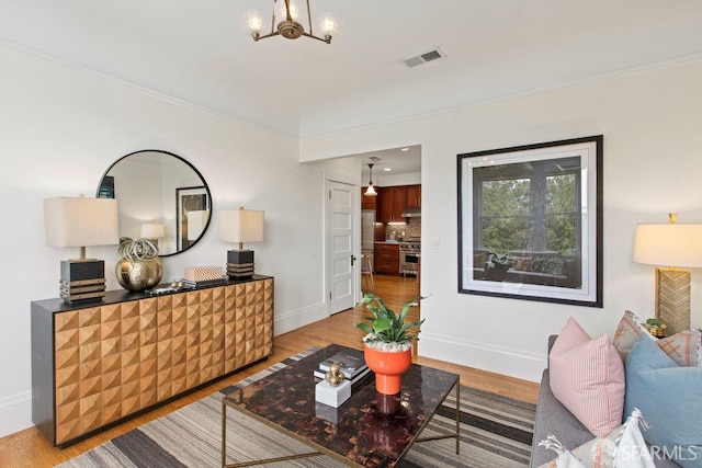 221 Noe St Unit 12, San Francisco, CA 94114 - living area with light wood-type flooring, a chandelier, and ornamental molding