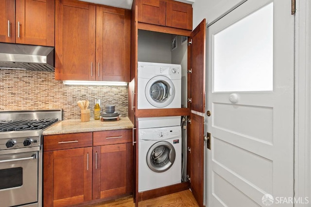 221 Noe St Unit 12, San Francisco, CA 94114 - washroom with stacked washing machine and dryer and light wood-type flooring