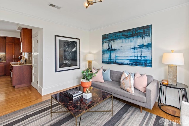 221 Noe St Unit 12, San Francisco, CA 94114 - living room featuring light wood-style floors and crown molding
