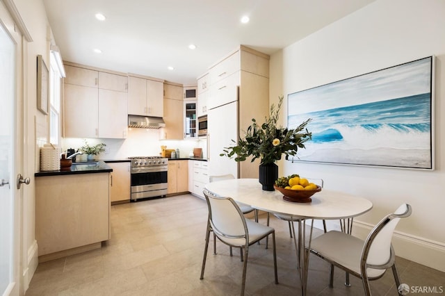 kitchen featuring stainless steel appliances, extractor fan, and tasteful backsplash