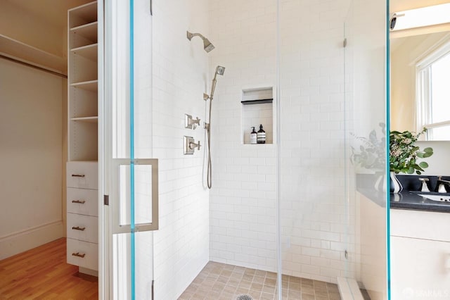 bathroom featuring wood-type flooring and an enclosed shower