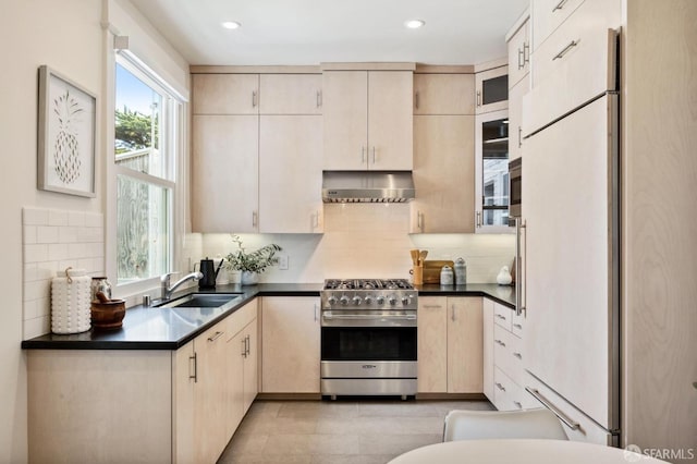 kitchen featuring sink, ventilation hood, backsplash, white refrigerator, and high end stove