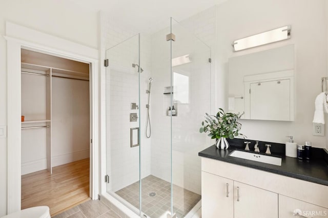 bathroom featuring vanity, hardwood / wood-style floors, and an enclosed shower