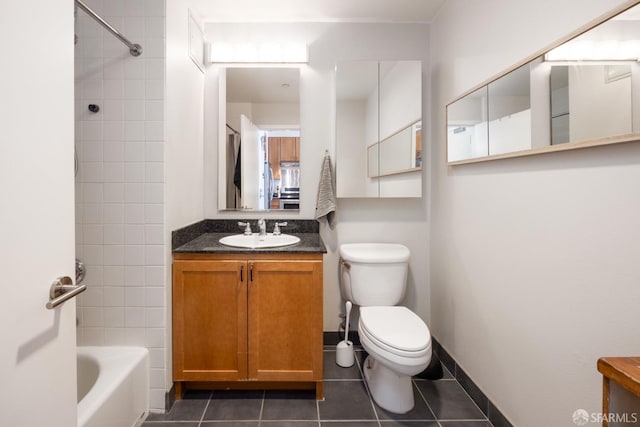 full bathroom featuring tiled shower / bath combo, tile patterned flooring, vanity, and toilet