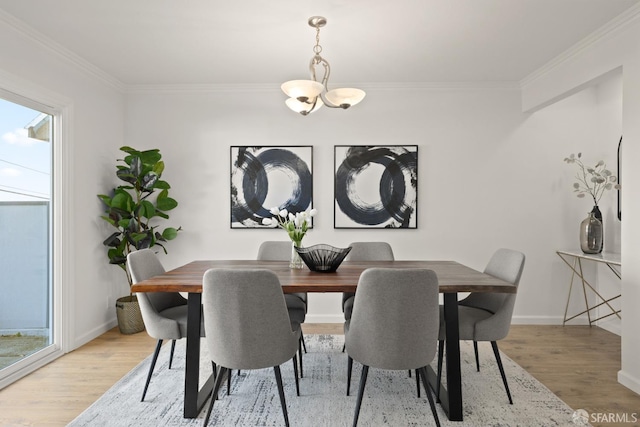 dining space with an inviting chandelier, baseboards, crown molding, and light wood-style floors