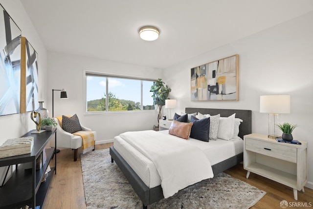 bedroom with wood finished floors and baseboards