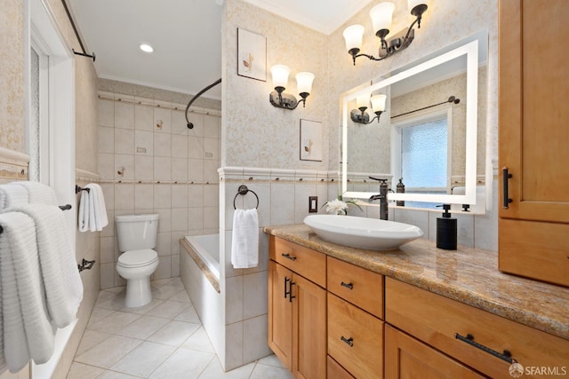 bathroom featuring tile walls, toilet, ornamental molding, tile patterned floors, and vanity