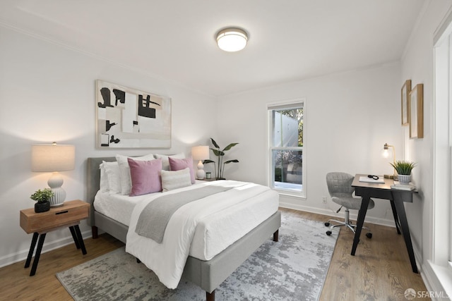 bedroom featuring baseboards and wood finished floors