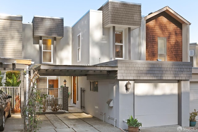 view of front of home with stucco siding and a garage