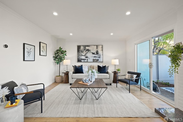 living area with crown molding, recessed lighting, baseboards, and light wood finished floors