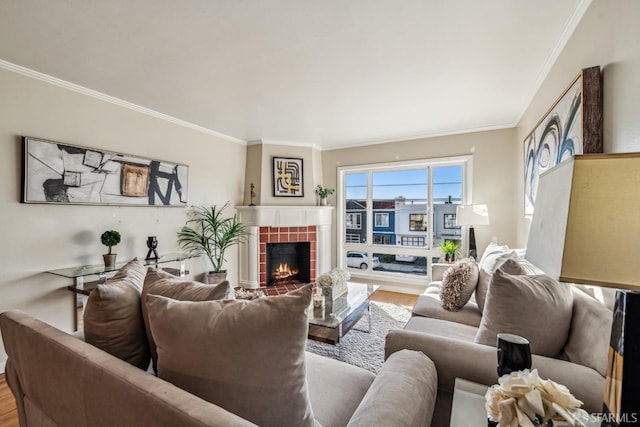 living room featuring a fireplace, ornamental molding, and hardwood / wood-style floors