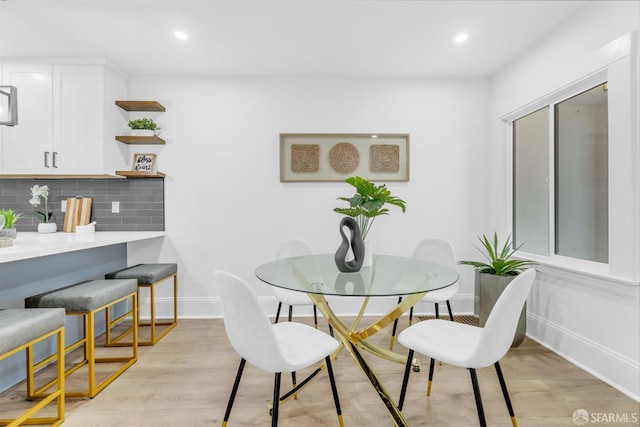 dining area with light wood-type flooring, baseboards, and recessed lighting