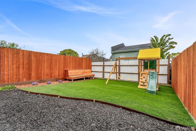 view of yard featuring a playground and a fenced backyard