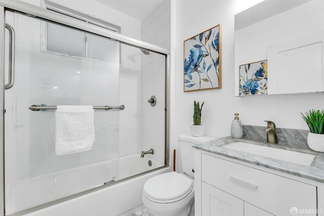 bathroom featuring shower / bath combination with glass door, vanity, and toilet