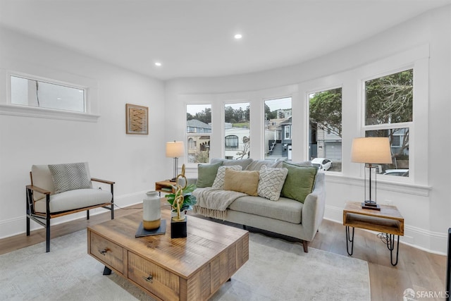 interior space featuring light wood-type flooring, baseboards, and recessed lighting