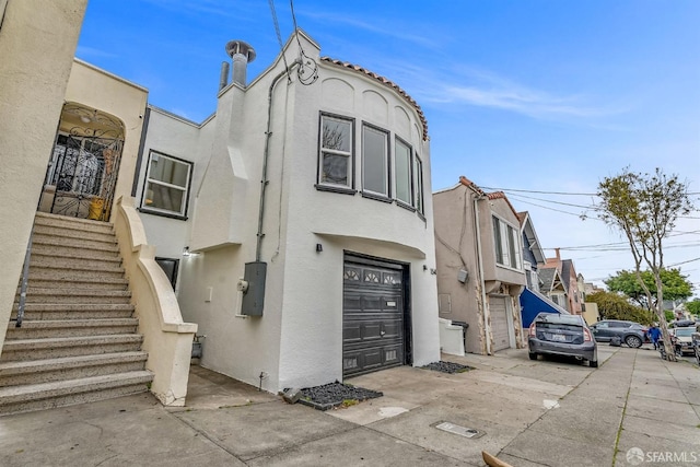 view of front of house featuring stairway and stucco siding