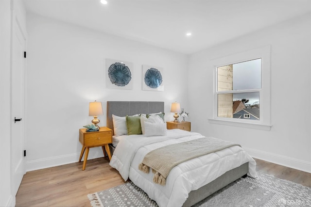 bedroom featuring recessed lighting, wood finished floors, and baseboards