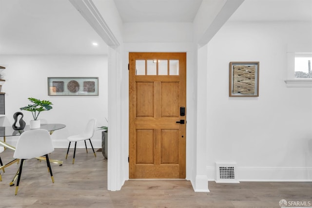 foyer entrance featuring light wood-style flooring, visible vents, baseboards, and recessed lighting