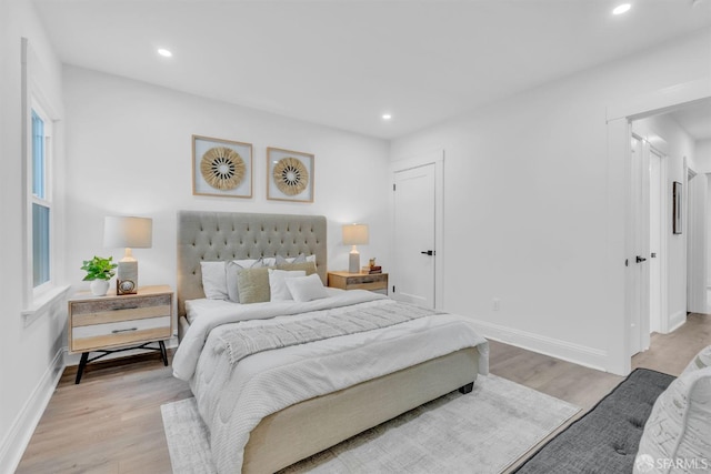 bedroom with light wood-style floors, recessed lighting, and baseboards