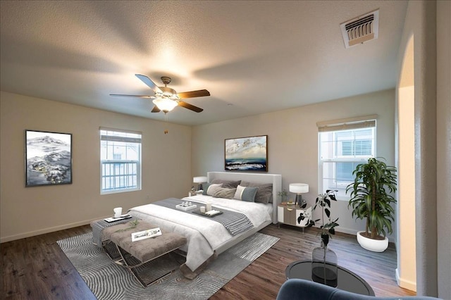 bedroom with ceiling fan and dark hardwood / wood-style flooring