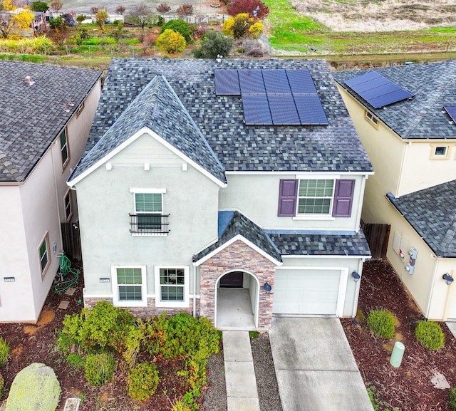 view of front of property with solar panels and a garage