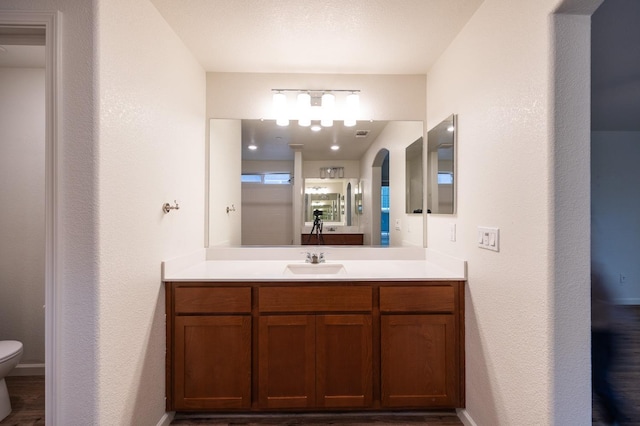 bathroom featuring vanity and toilet