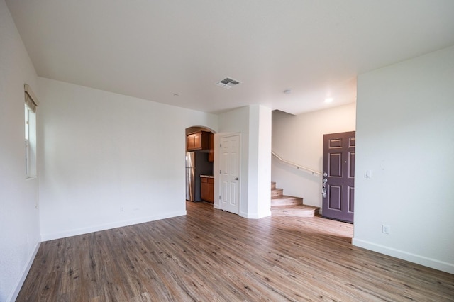 unfurnished room with hardwood / wood-style floors