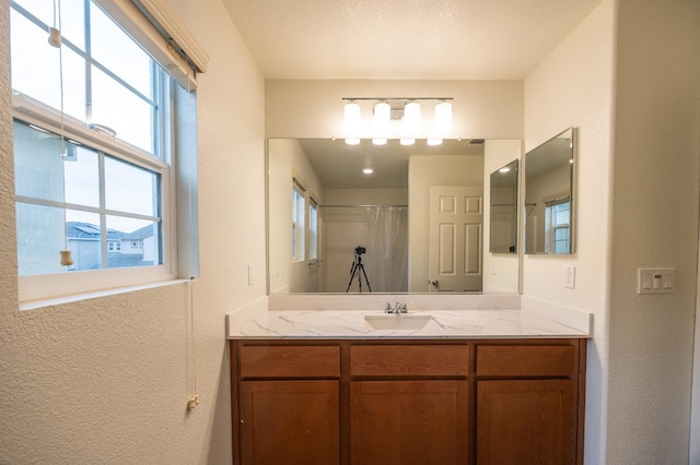 bathroom featuring vanity and walk in shower