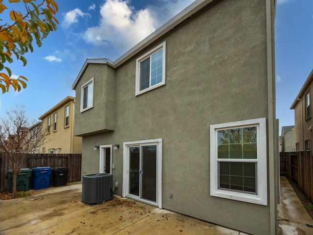 back of house featuring central AC unit