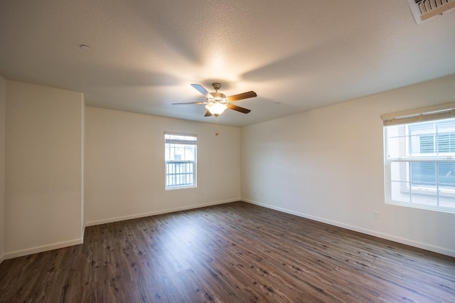 spare room featuring a textured ceiling, ceiling fan, and dark hardwood / wood-style floors