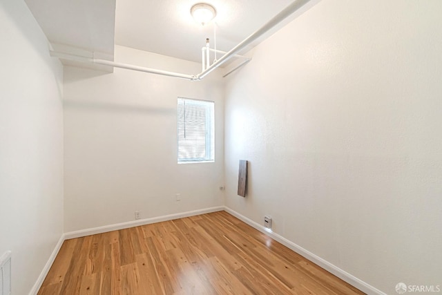 unfurnished room featuring light wood-type flooring and baseboards